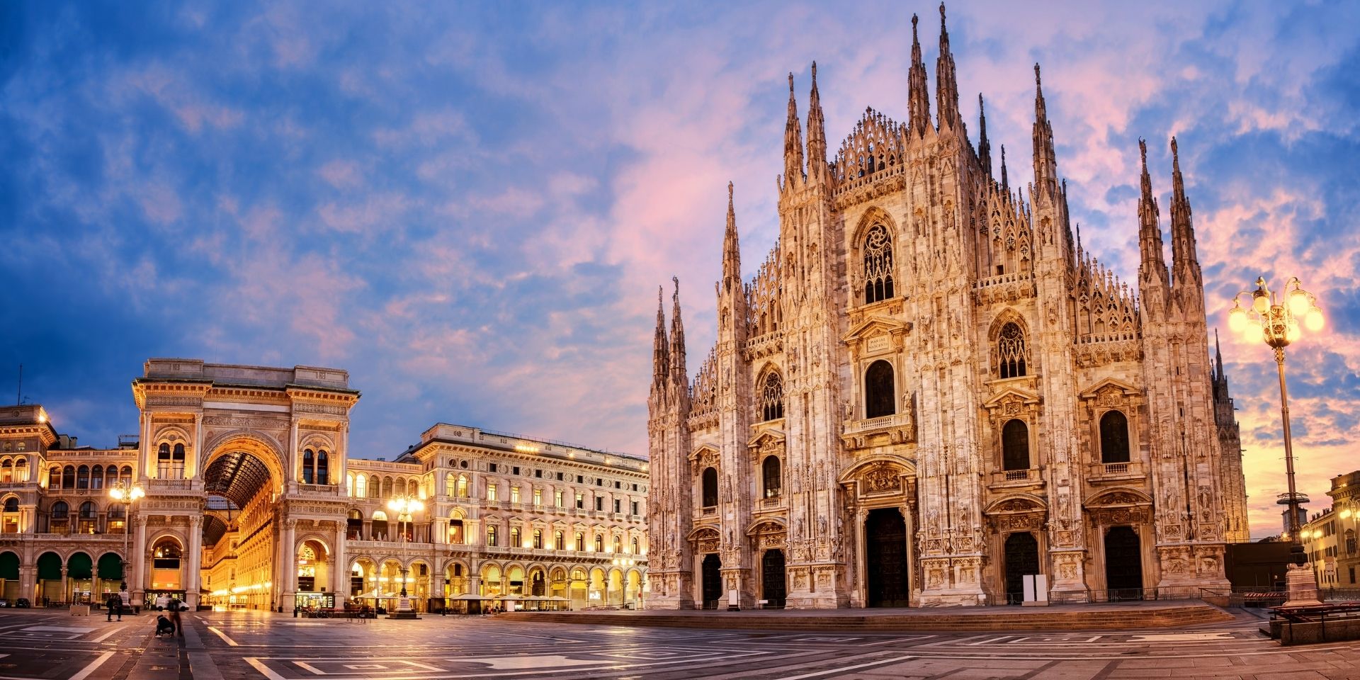 Duomo di Milano at dusk with a blue sky and clouds