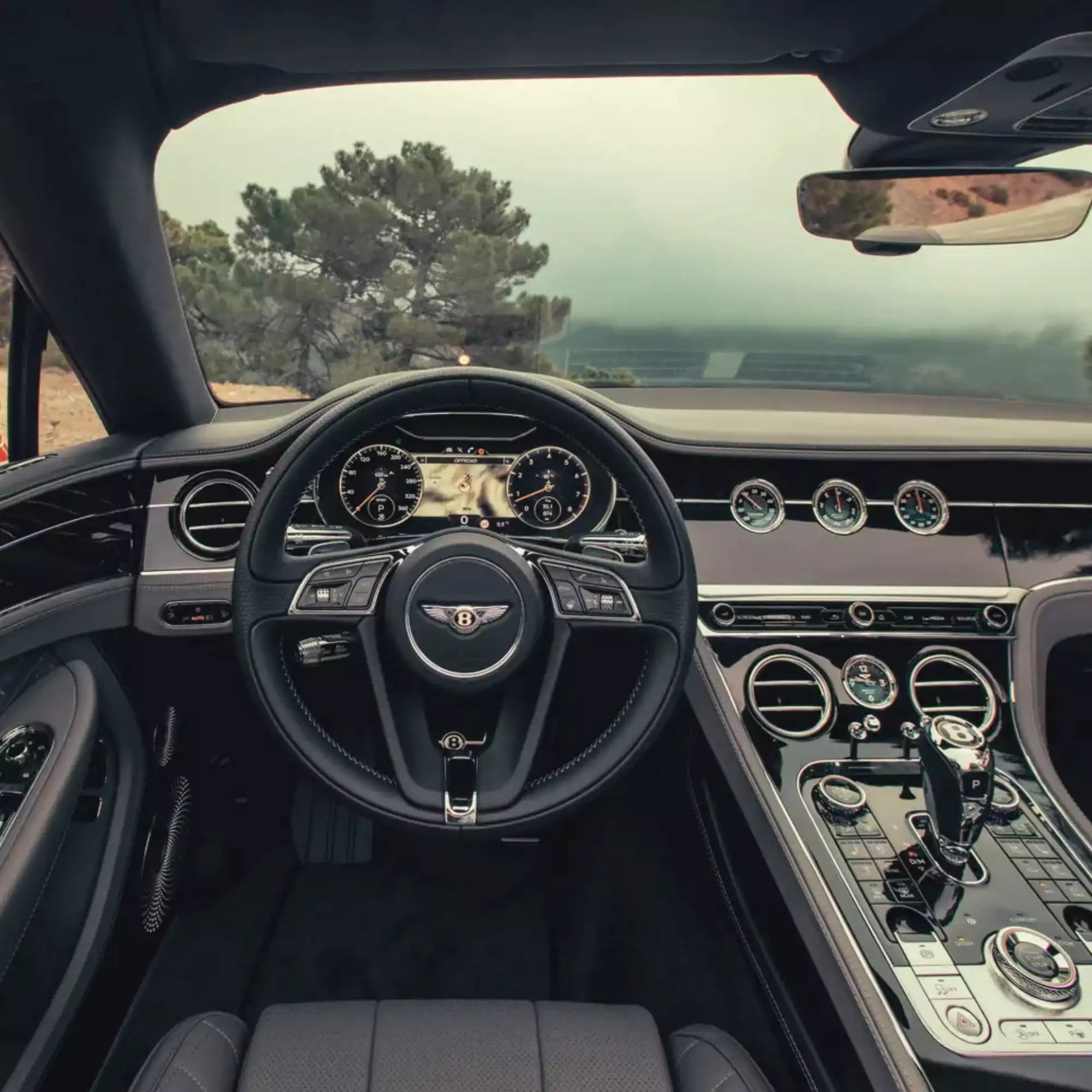 Luxury car interior with steering wheel and dashboard view