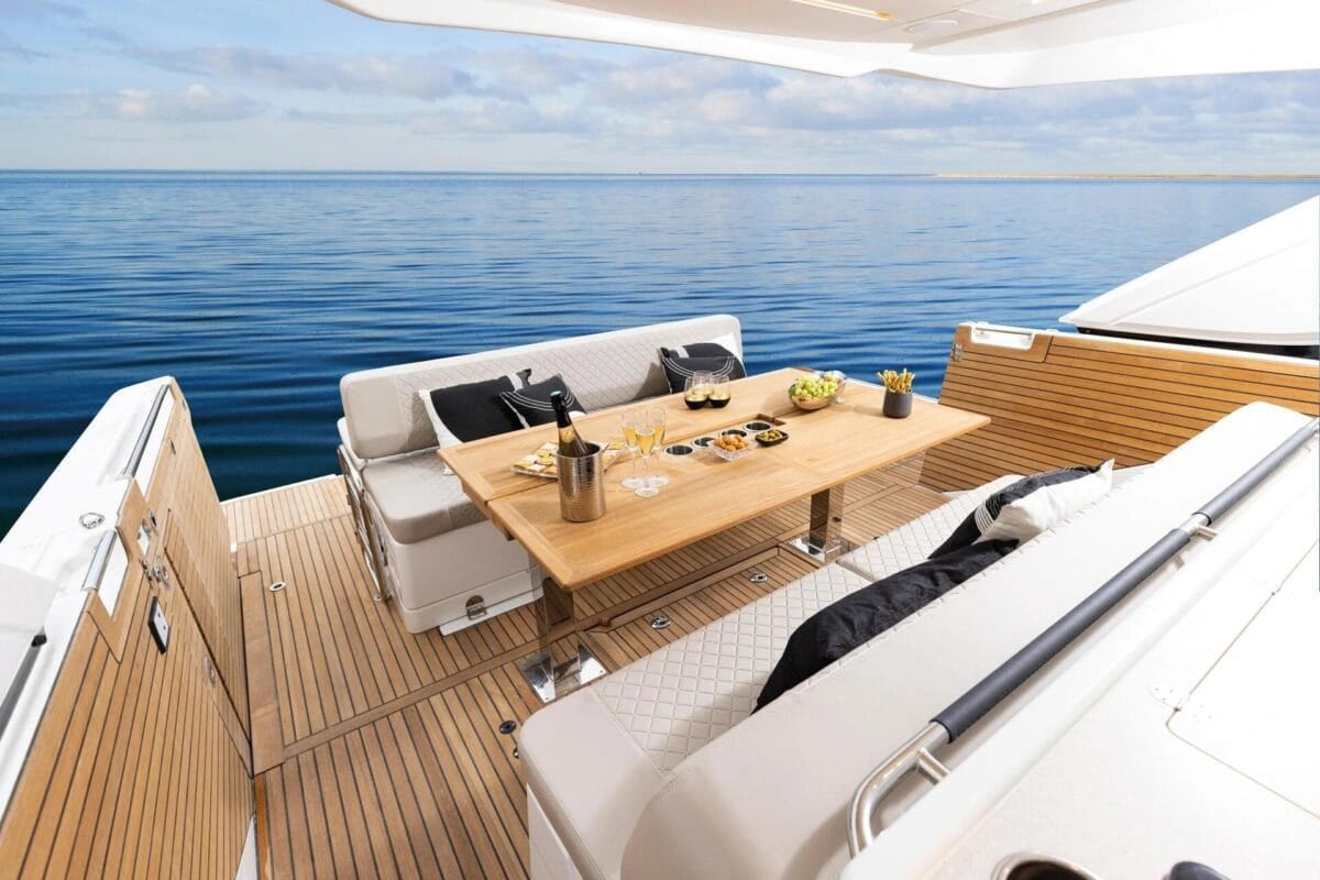 Yacht deck with seating area and table overlooking the ocean