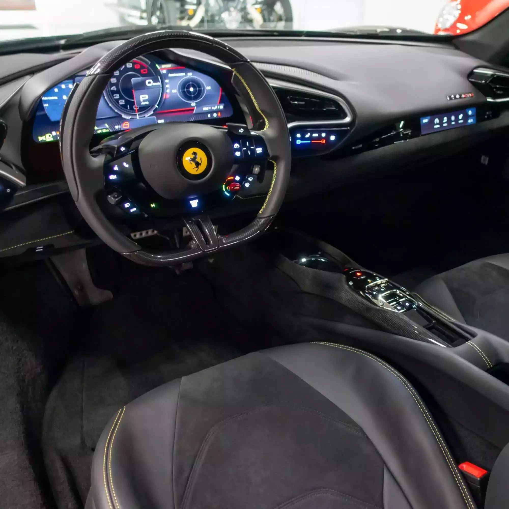 Car interior with steering wheel featuring Ferrari logo
