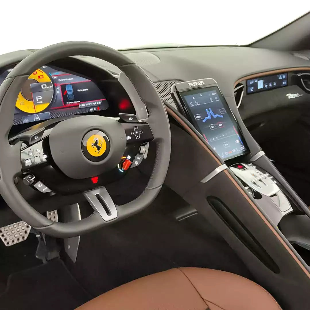Luxury car interior with steering wheel featuring Ferrari logo.