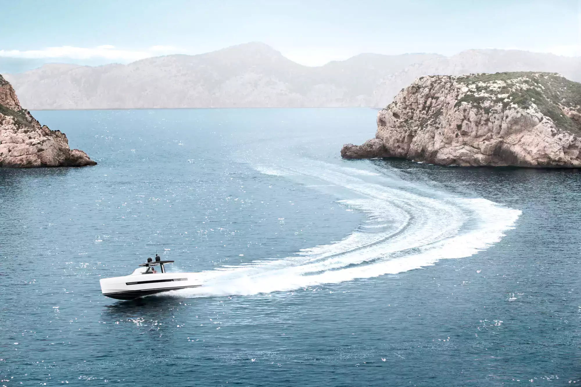 Speedboat on a body of water with rocky islands in the background