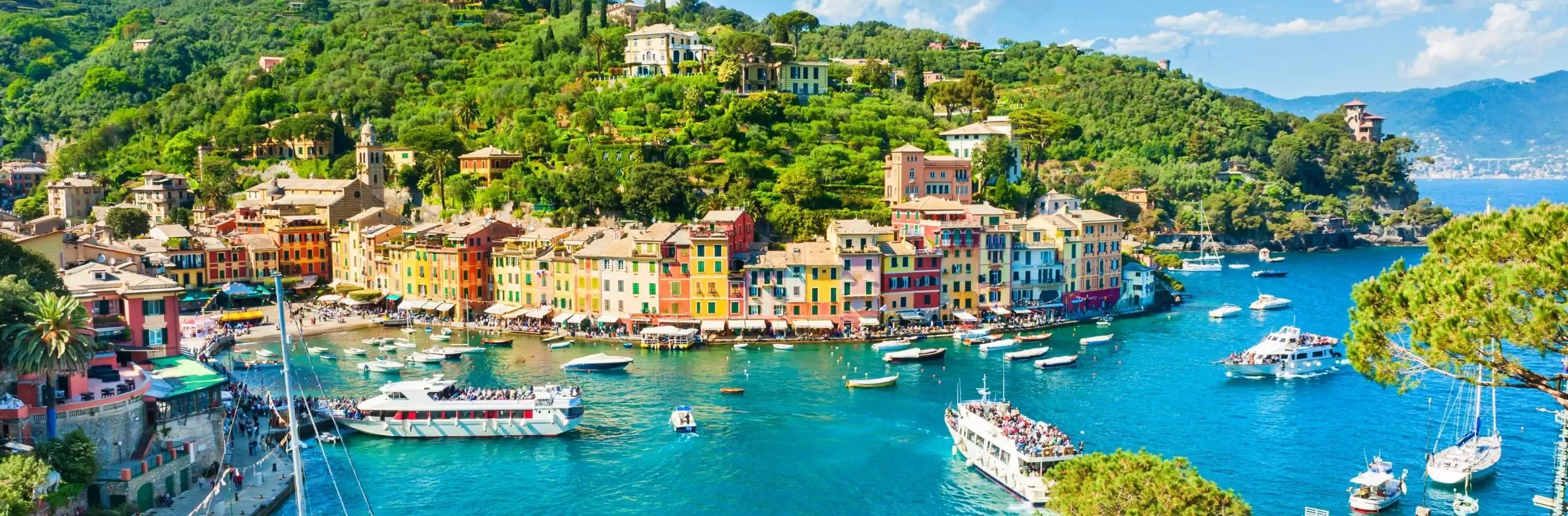 Colorful coastal town with boats in a bay on a sunny day