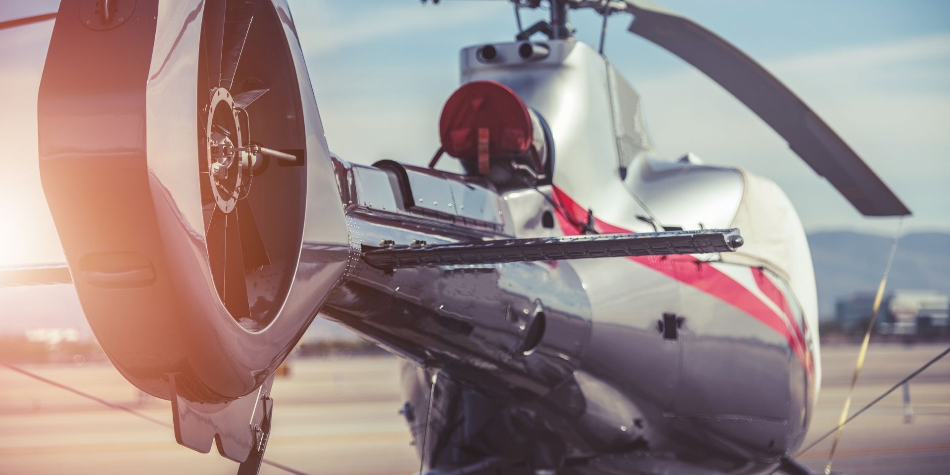 Close-up of a helicopter's rotor and fuselage with a blurred background
