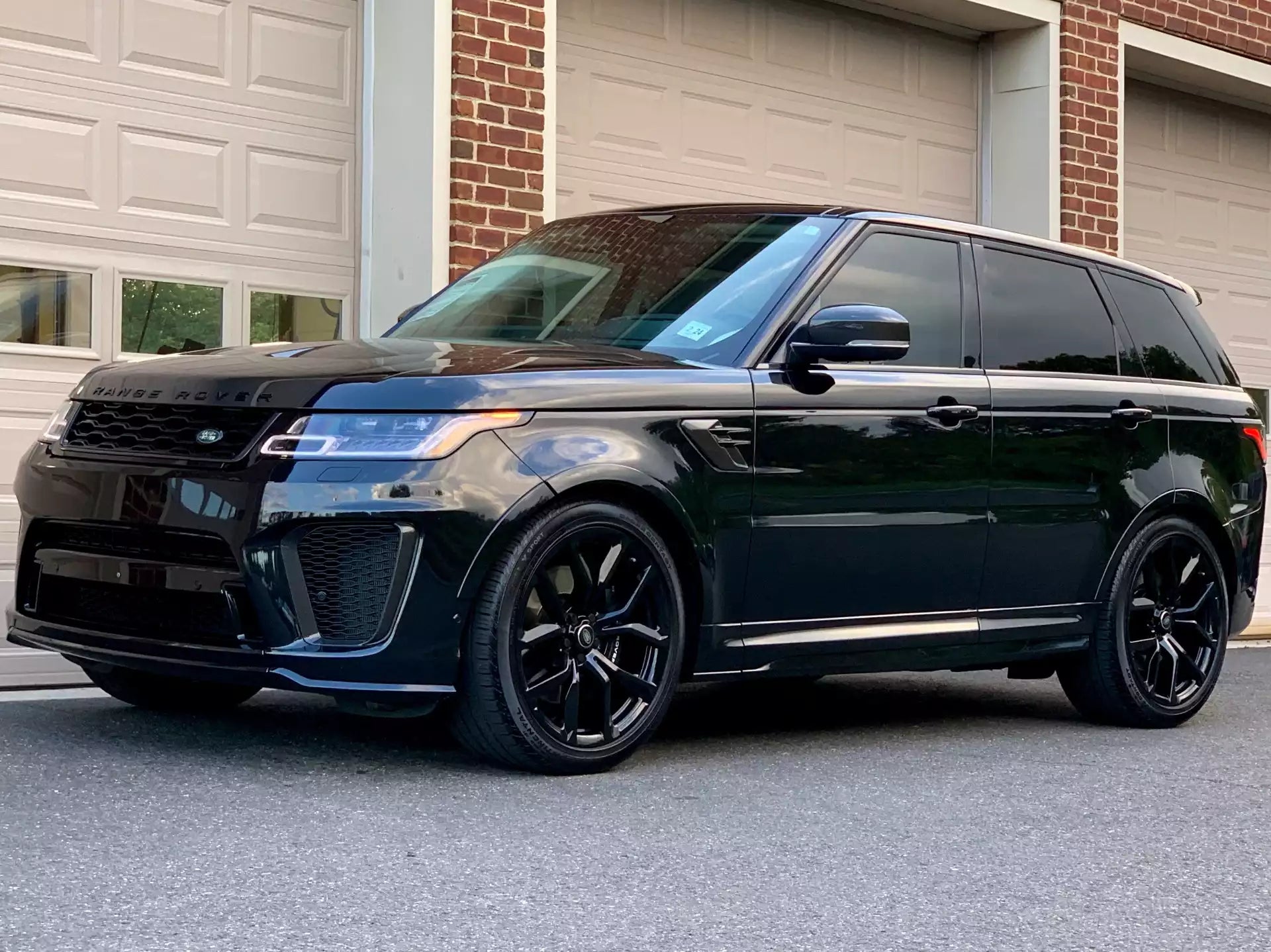Black SUV parked in front of a garage door