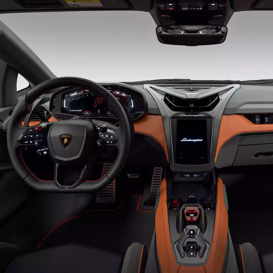 Luxury car interior with steering wheel and dashboard, featuring Lamborghini logo.