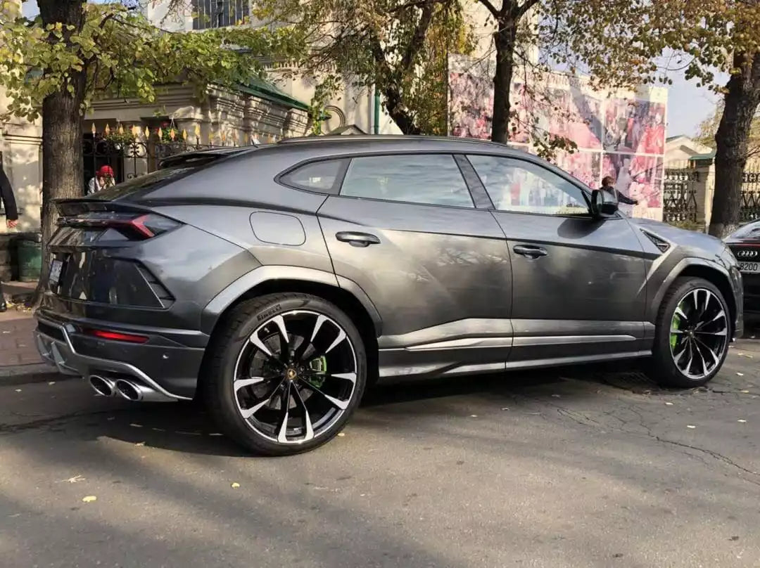 Luxury SUV parked on a city street with pedestrians in the background