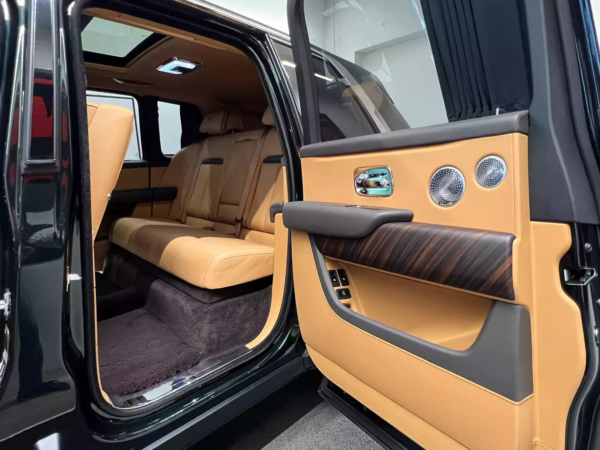 Luxurious car interior with beige leather seats and door panel.