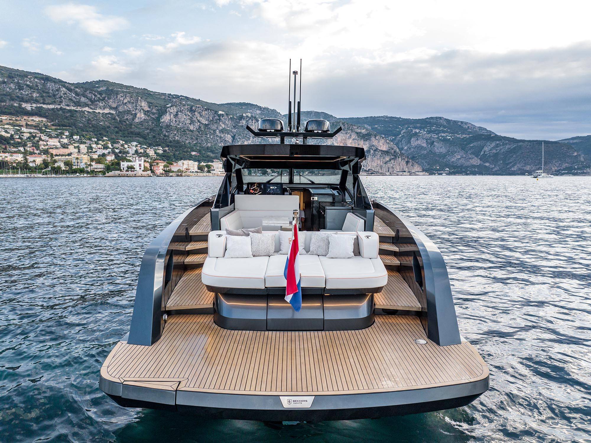 Luxury yacht on the water with mountains in the background