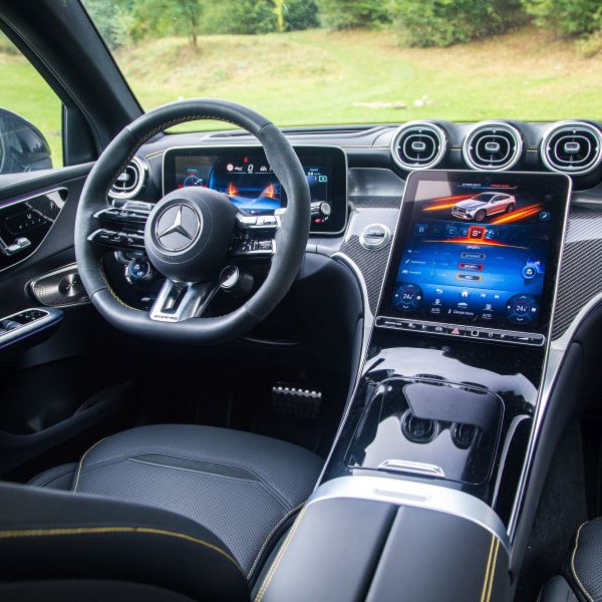 Car interior with steering wheel and dashboard featuring Mercedes-Benz logo
