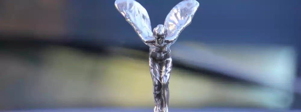 Close-up of the Rolls-Royce logo on a car hood