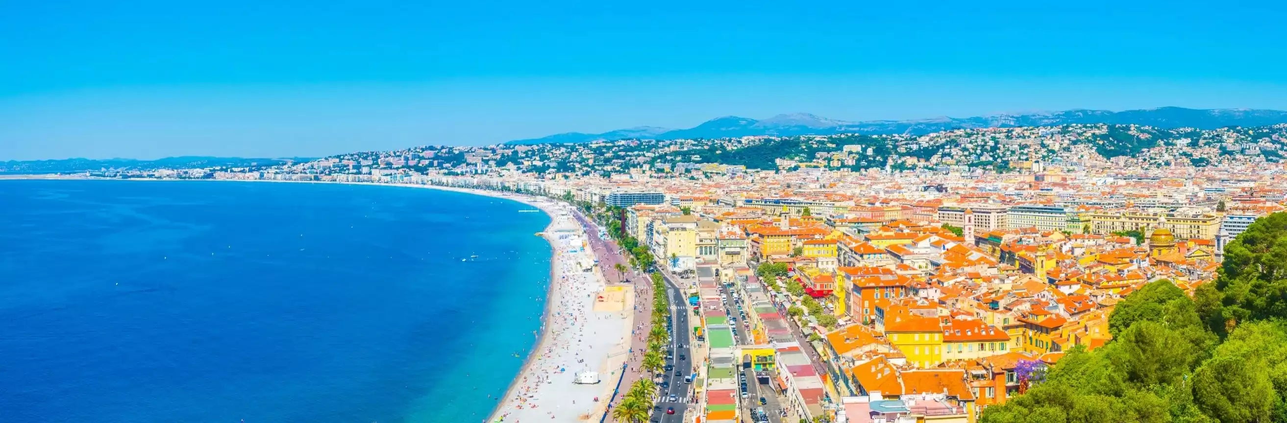 Panoramic view of a coastal city with blue sea and clear sky