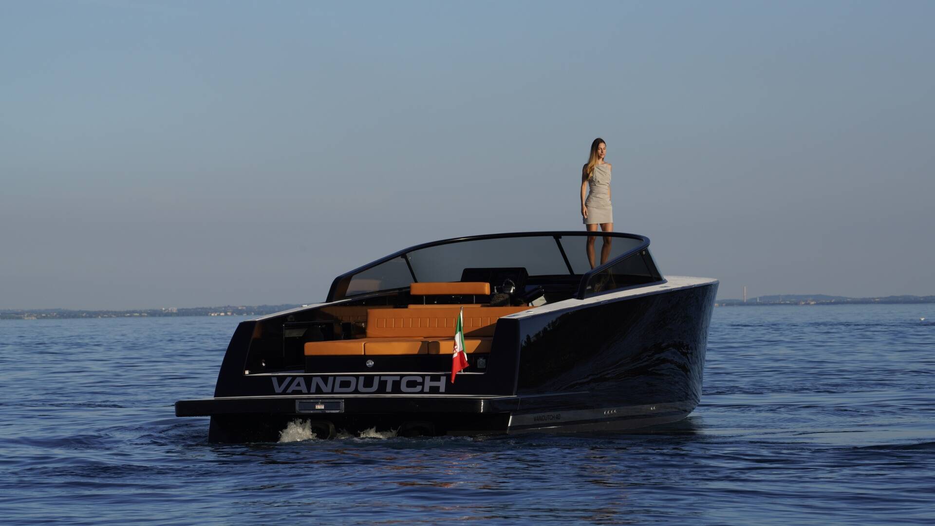 Vandutch boat on water with a person standing on the deck