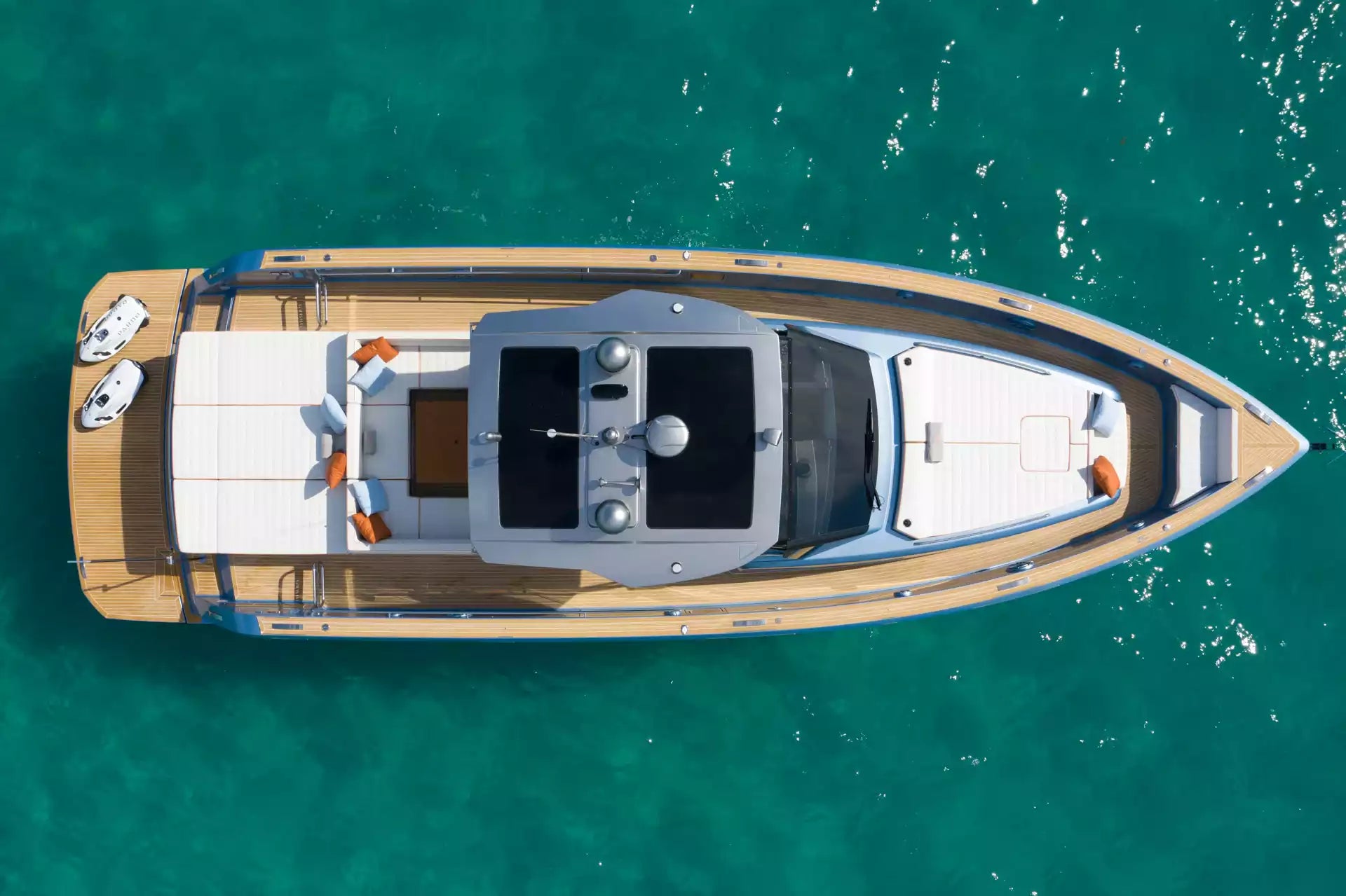 Top-down view of a yacht on clear blue water