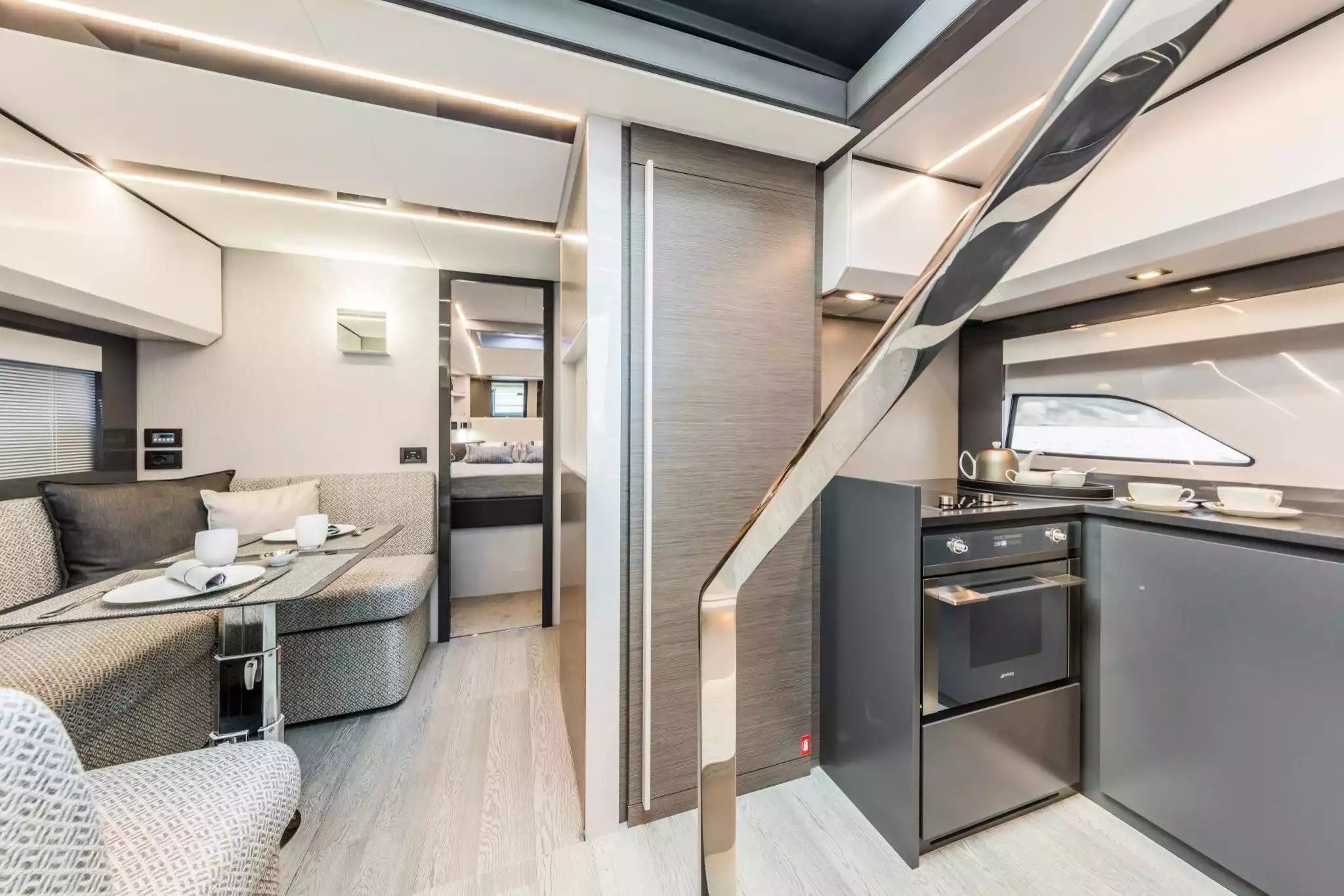 Modern interior of a yacht with living area and kitchen.