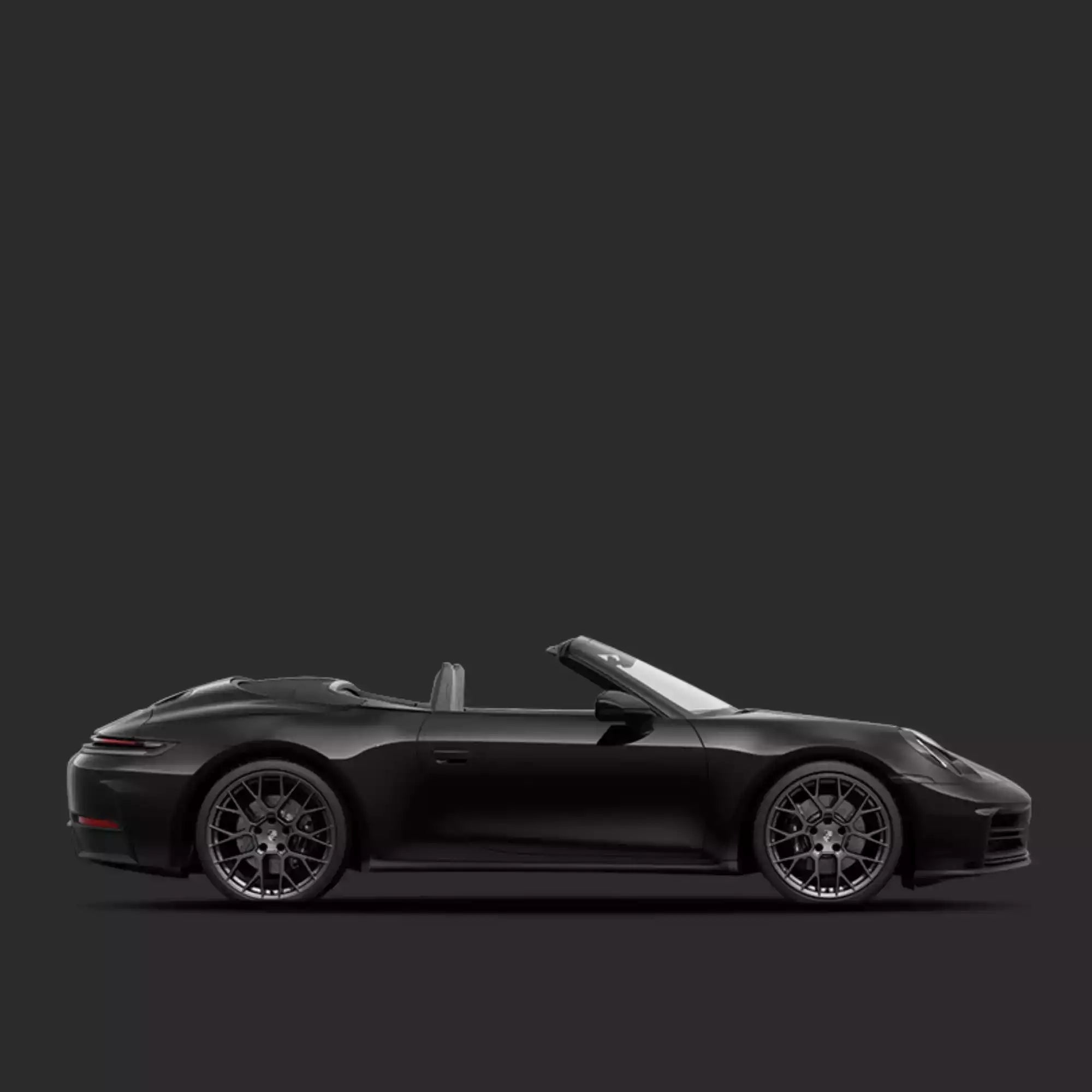 Side view of a black Porsche sports car on a dark background
