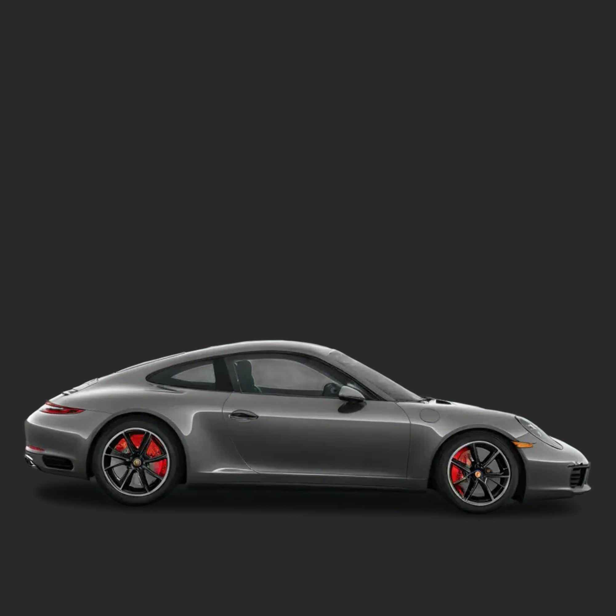 Side view of a gray sports car with red accents on a black background