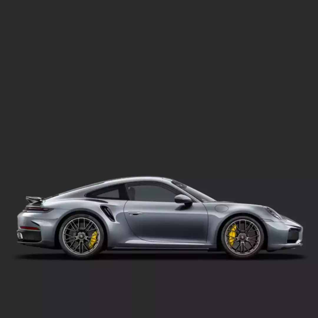 Silver sports car with yellow brake calipers on a black background