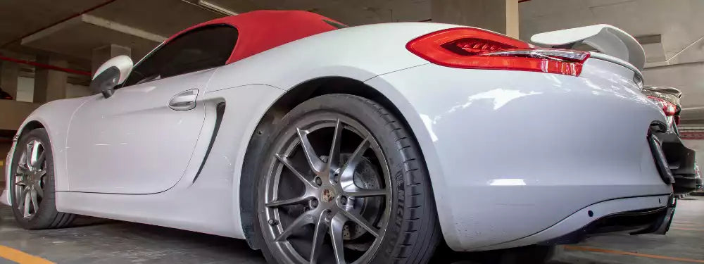 White sports car with red interior in a garage