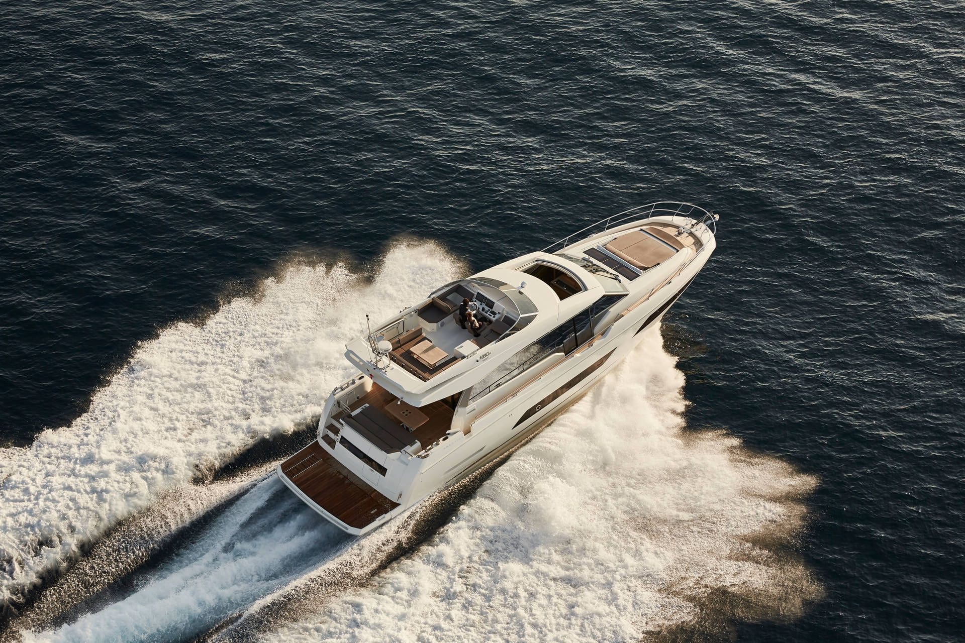 Luxury yacht speeding across a body of water