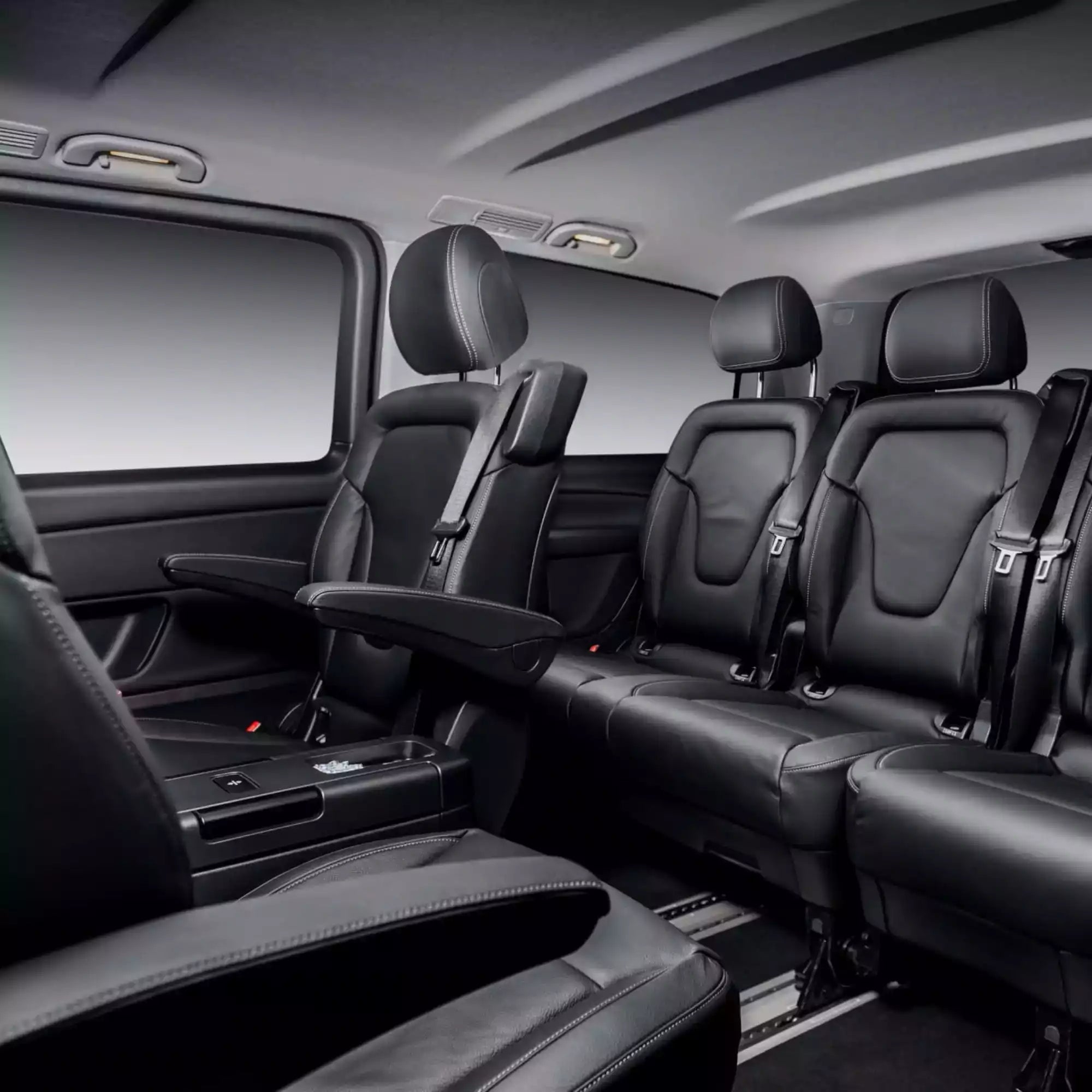 Black leather interior of a car with multiple seats