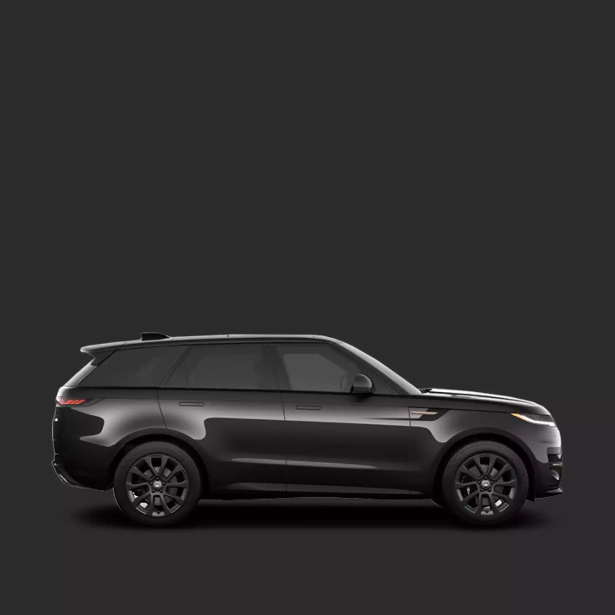 Side view of a black SUV on a dark background