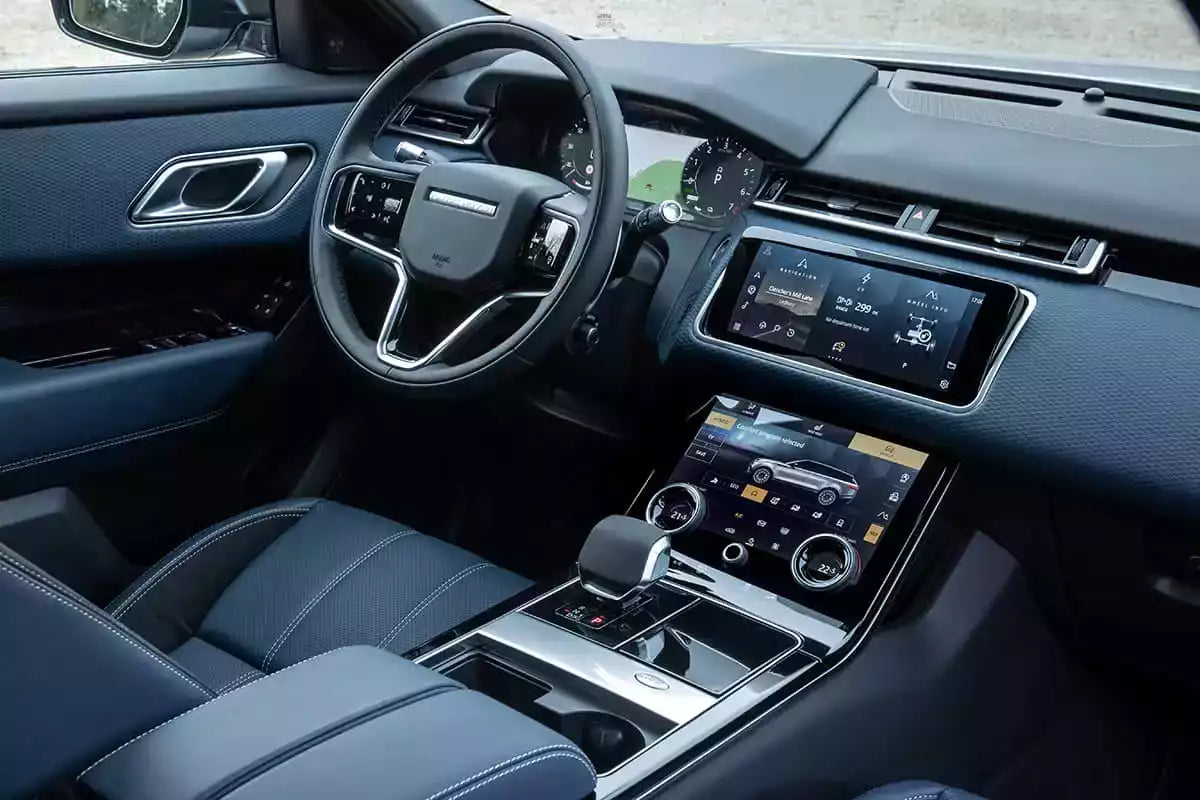 Car interior with steering wheel, dashboard, and center console.