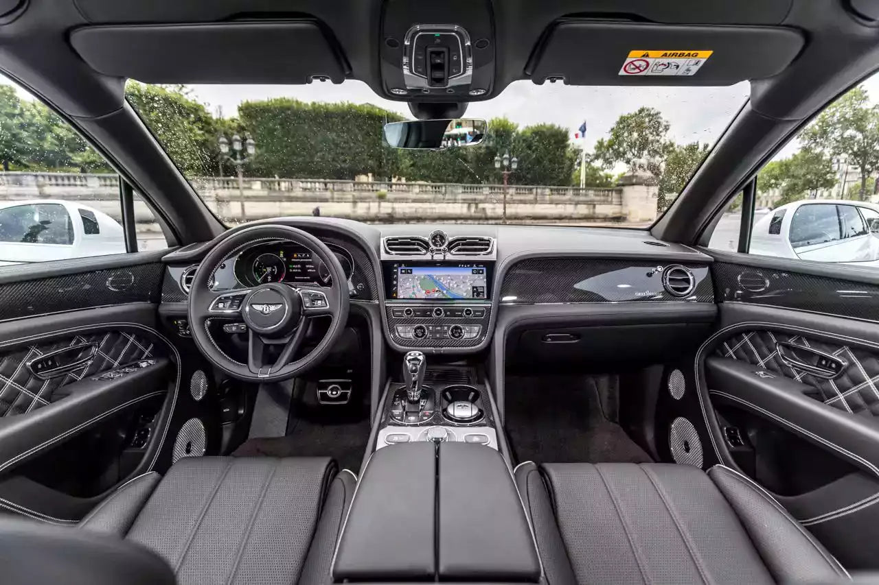 Luxury car interior with dashboard, steering wheel, and seats.