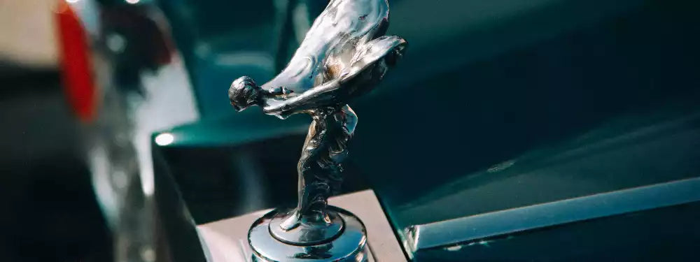Close-up of a Rolls-Royce hood ornament on a car