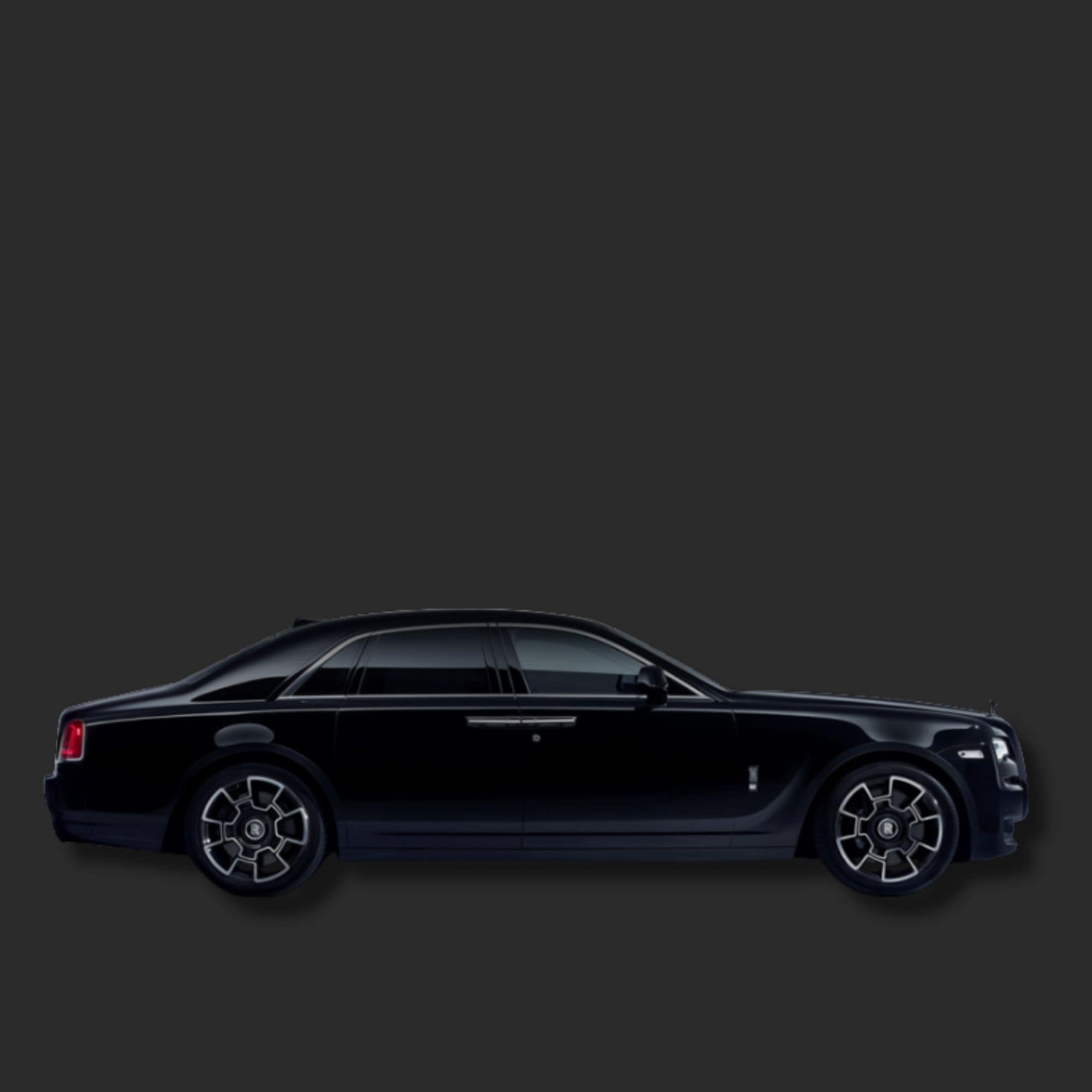A black Rolls-Royce Ghost sedan shown in a side profile view against a solid dark gray background.