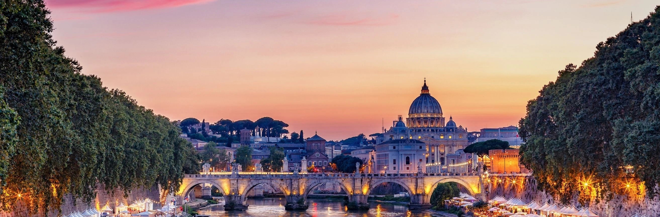 Sunset over St. Peter's Basilica and the Tiber River in Rome, Italy.