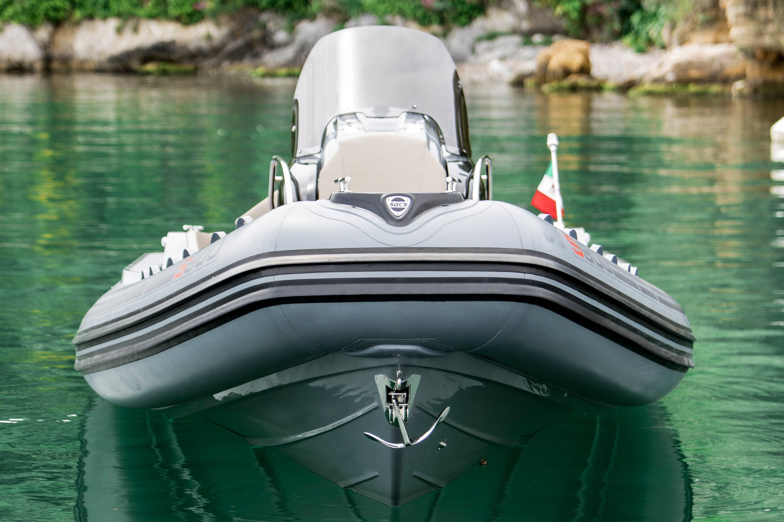 Inflatable boat on calm water with a scenic background