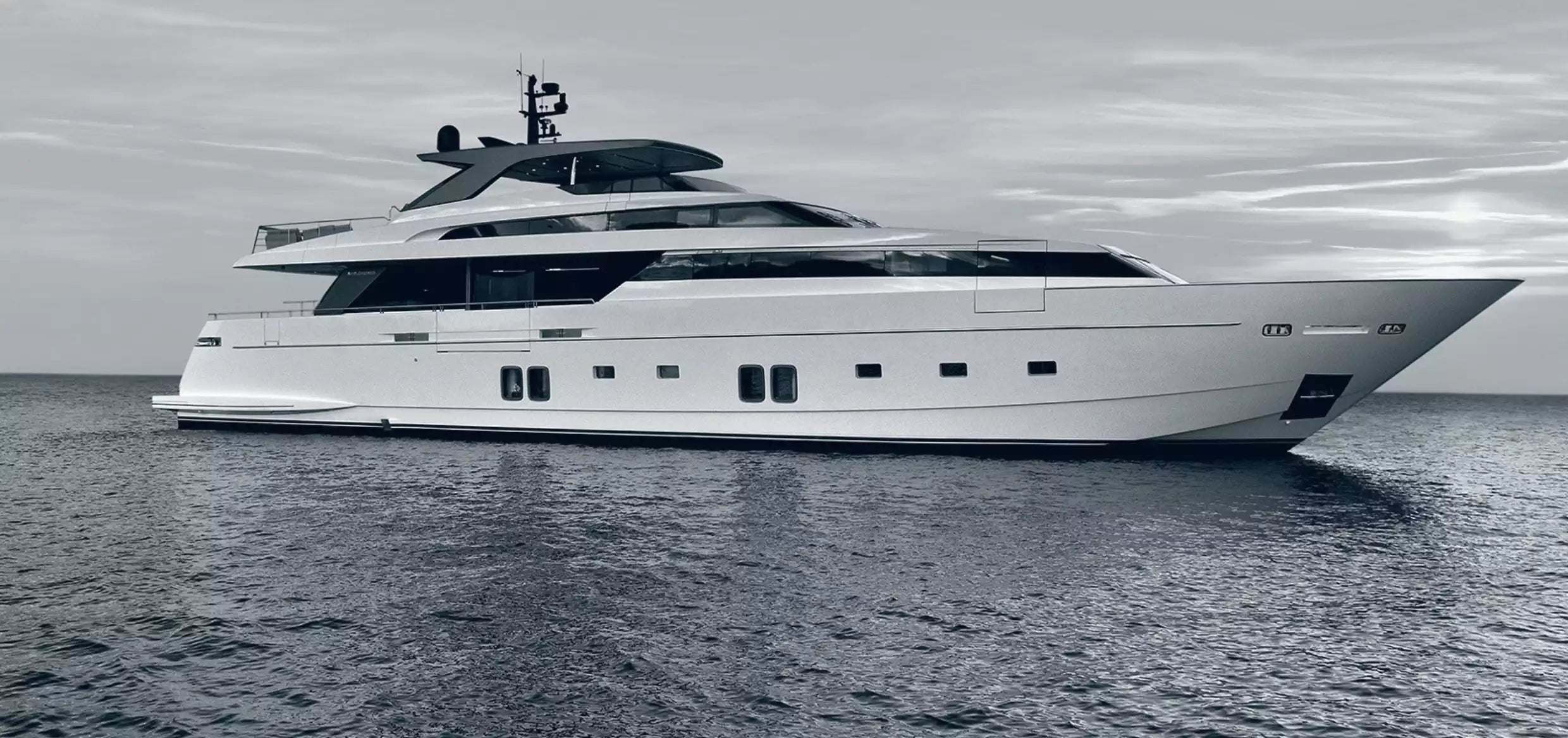 White yacht on the water with a gray sky