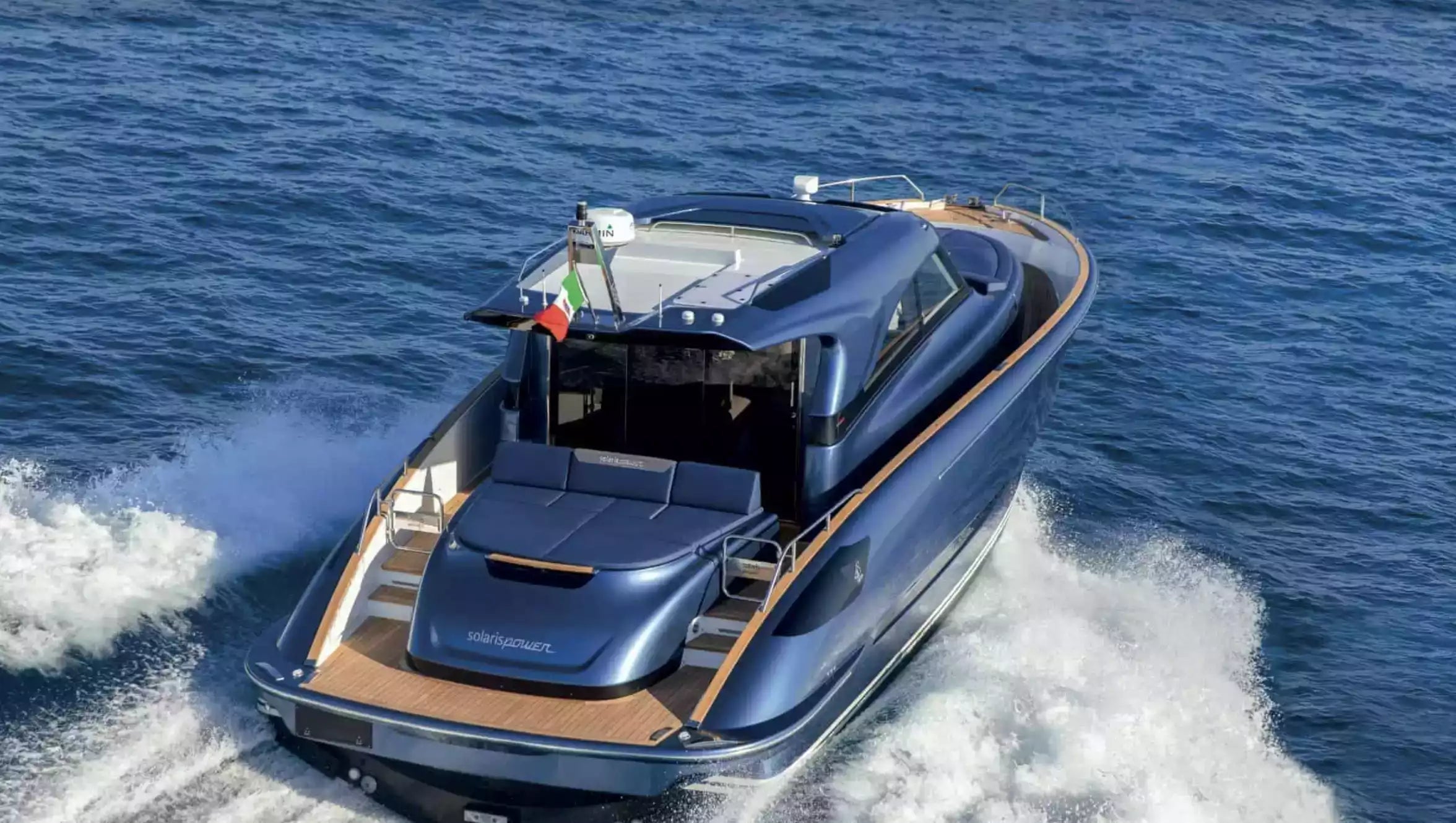 Blue luxury yacht speeding across the water