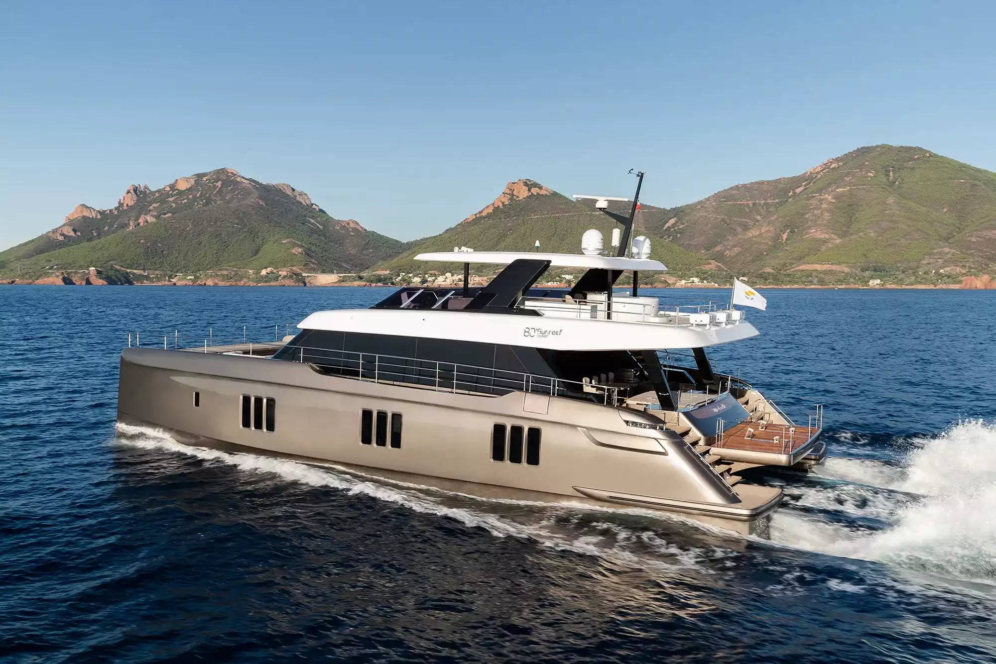 Luxury yacht on the water with mountains in the background