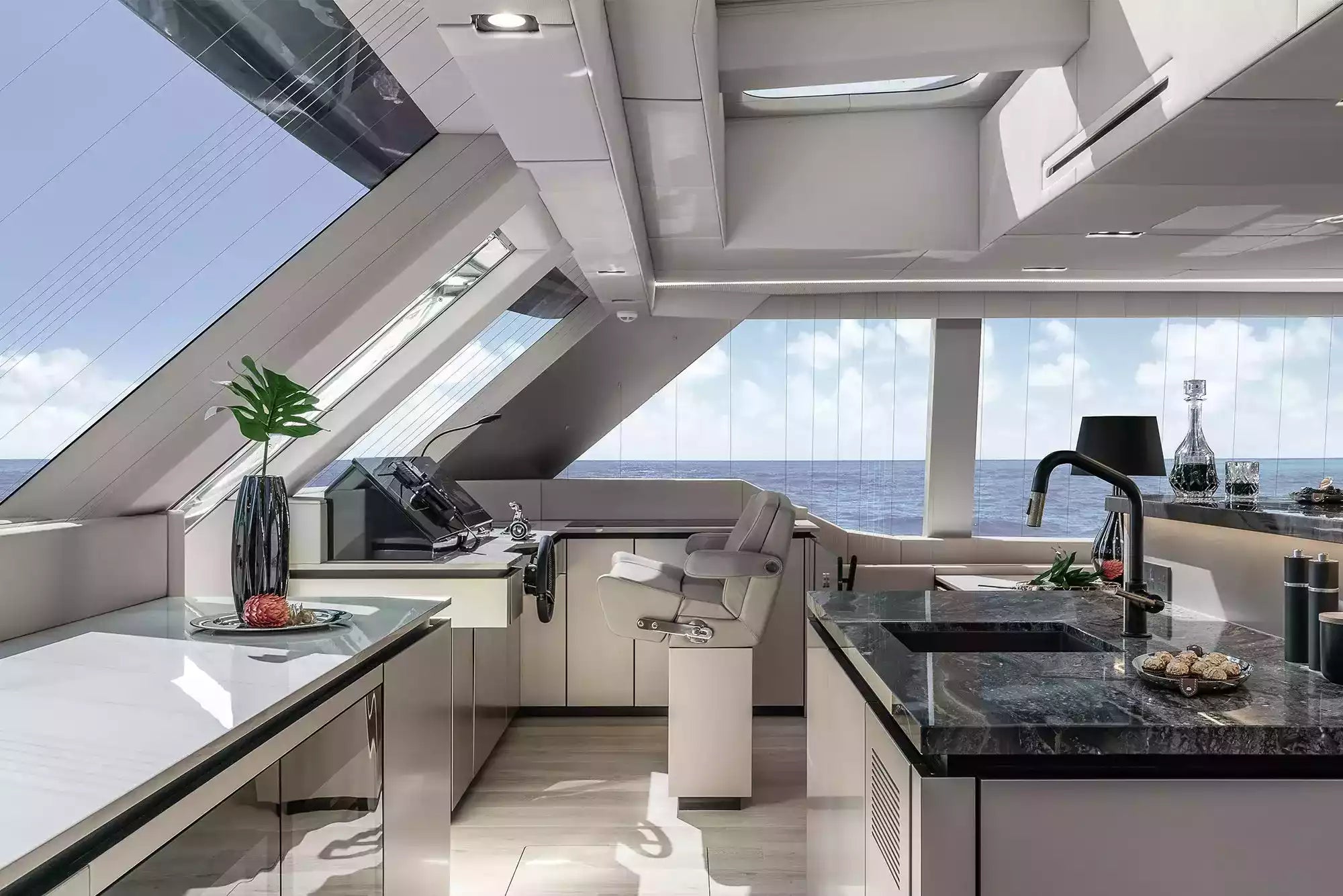 Modern yacht kitchen with large windows and a view of the ocean.