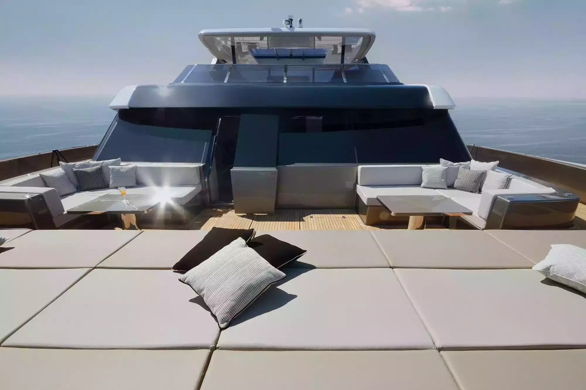 Yacht deck with outdoor seating area and ocean view