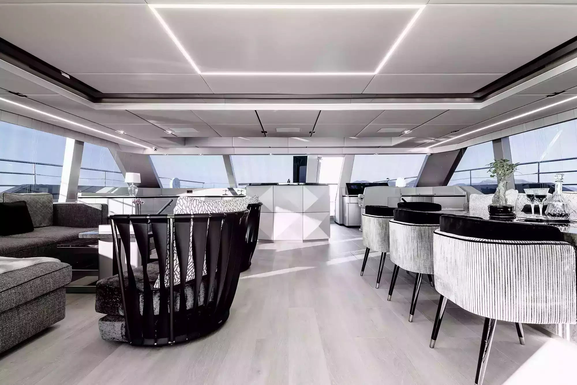 Modern yacht interior with dining area and lounge.