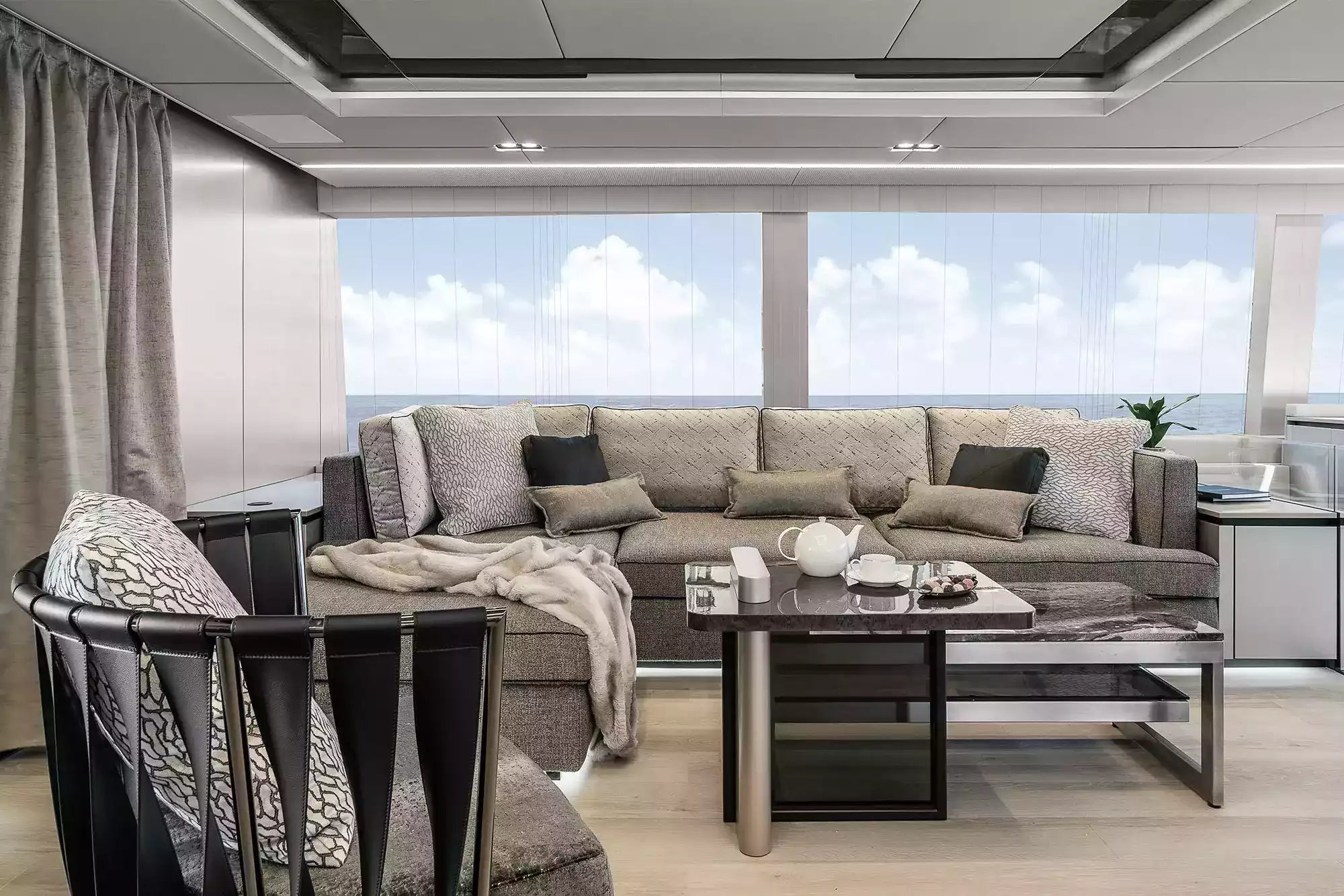 Modern living room with a large sectional sofa, coffee table, and decorative items.