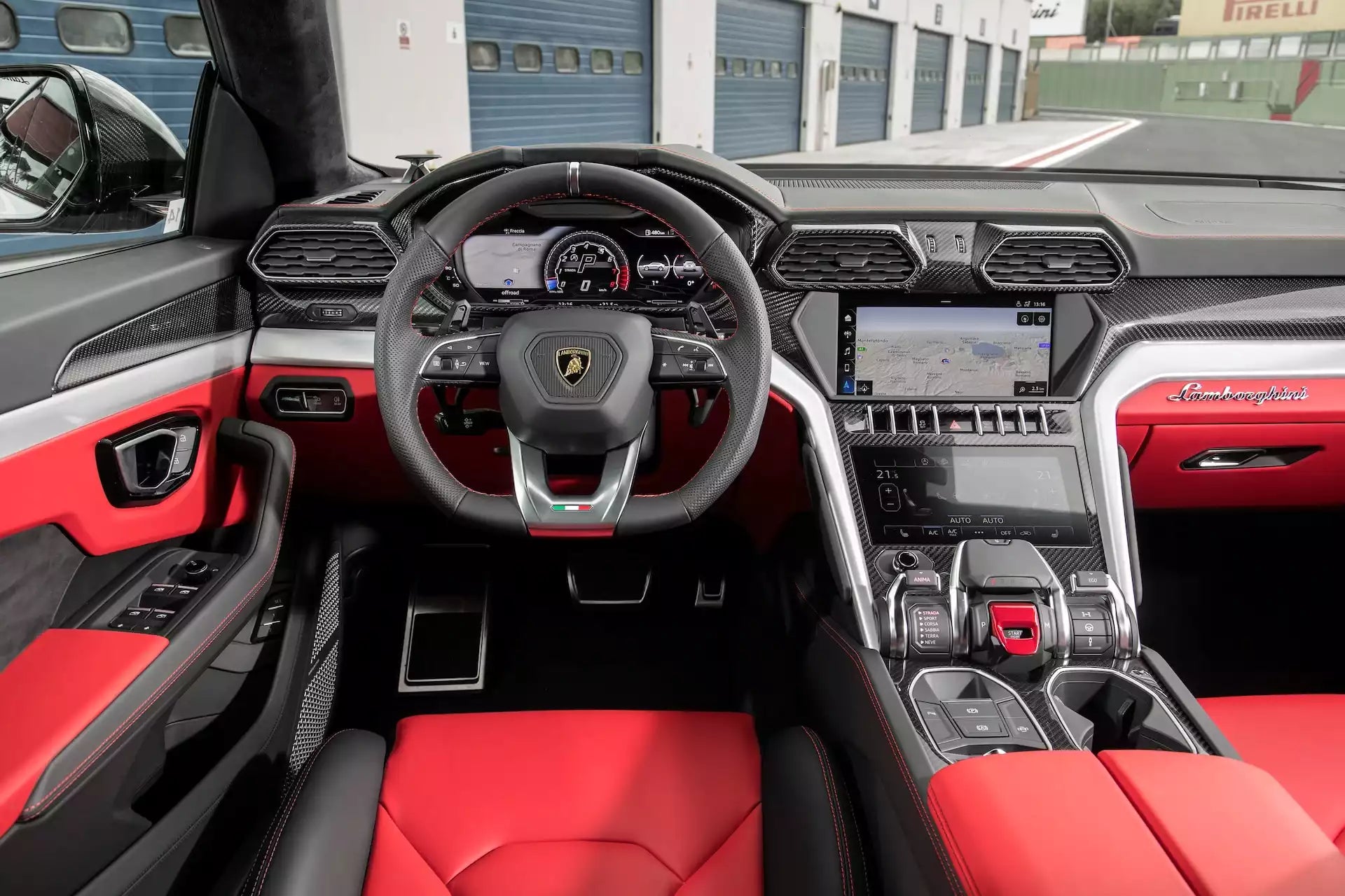 Luxury car interior with red and black design, featuring a prominent steering wheel logo.