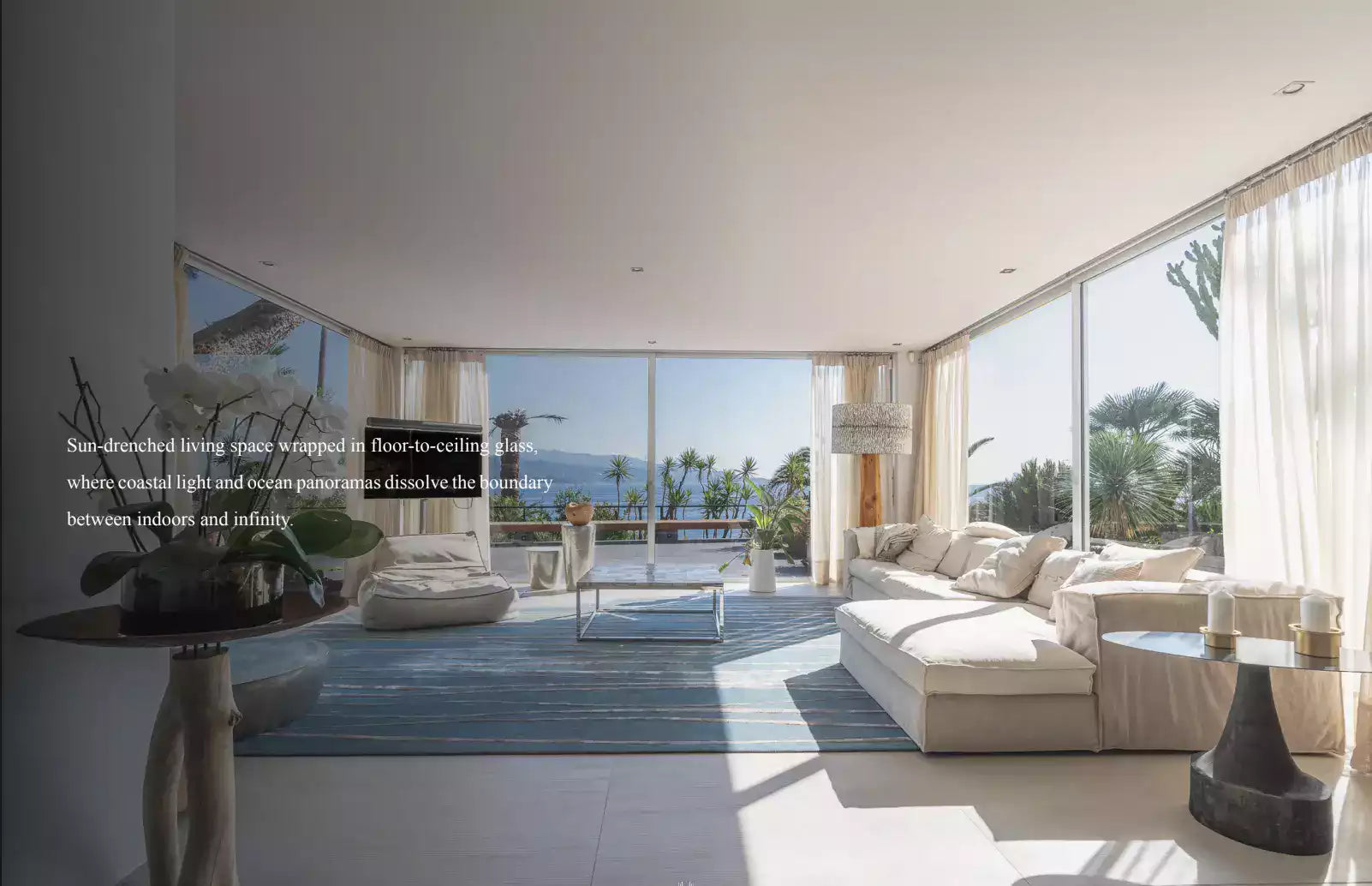 Modern living room with floor-to-ceiling windows overlooking a scenic view.