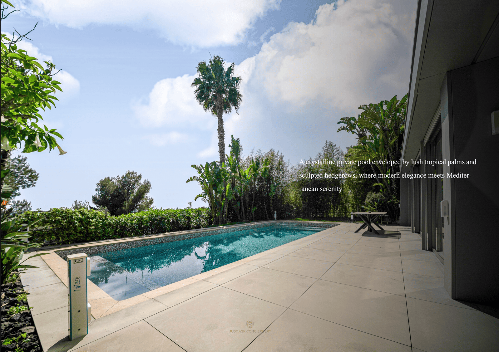 Modern pool area with a house, palm trees, and blue sky.