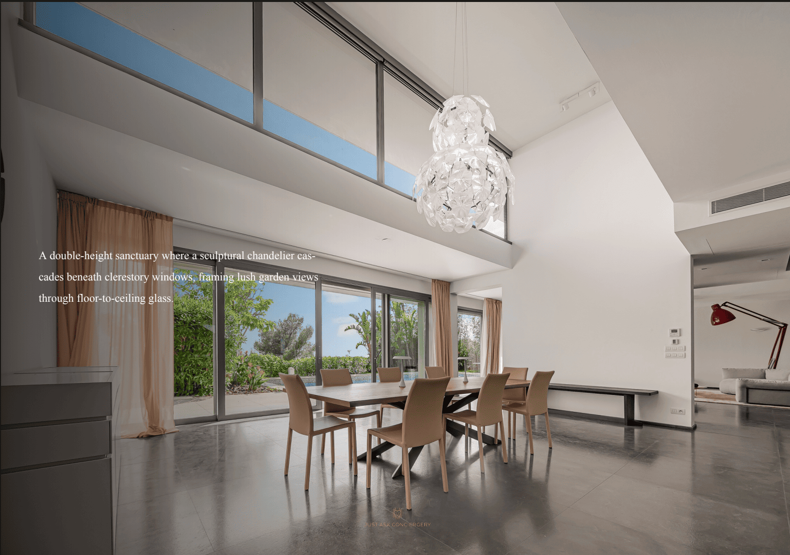 Modern dining room with large windows and a chandelier