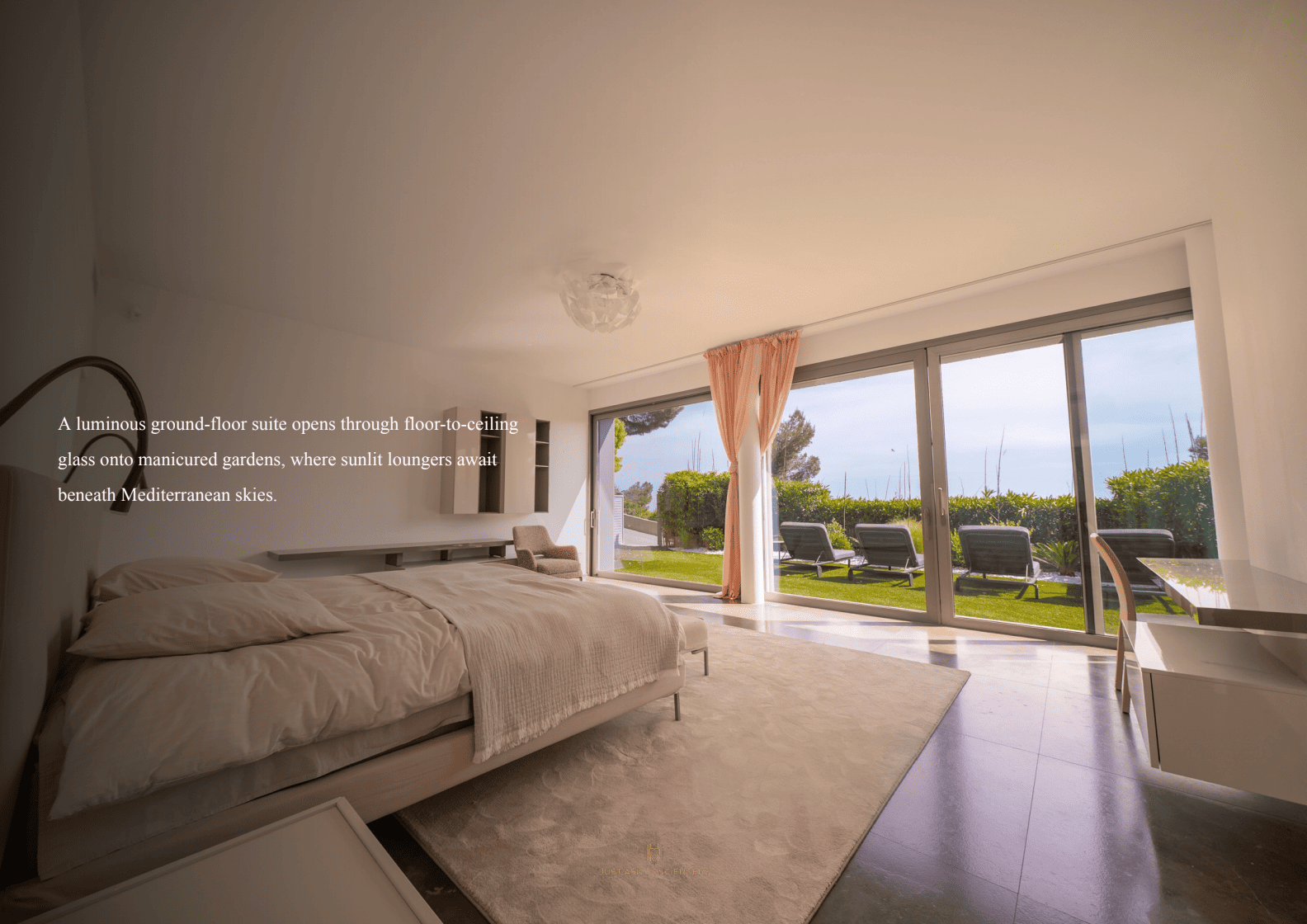 Modern bedroom with a large window view of a garden and Mediterranean sky.