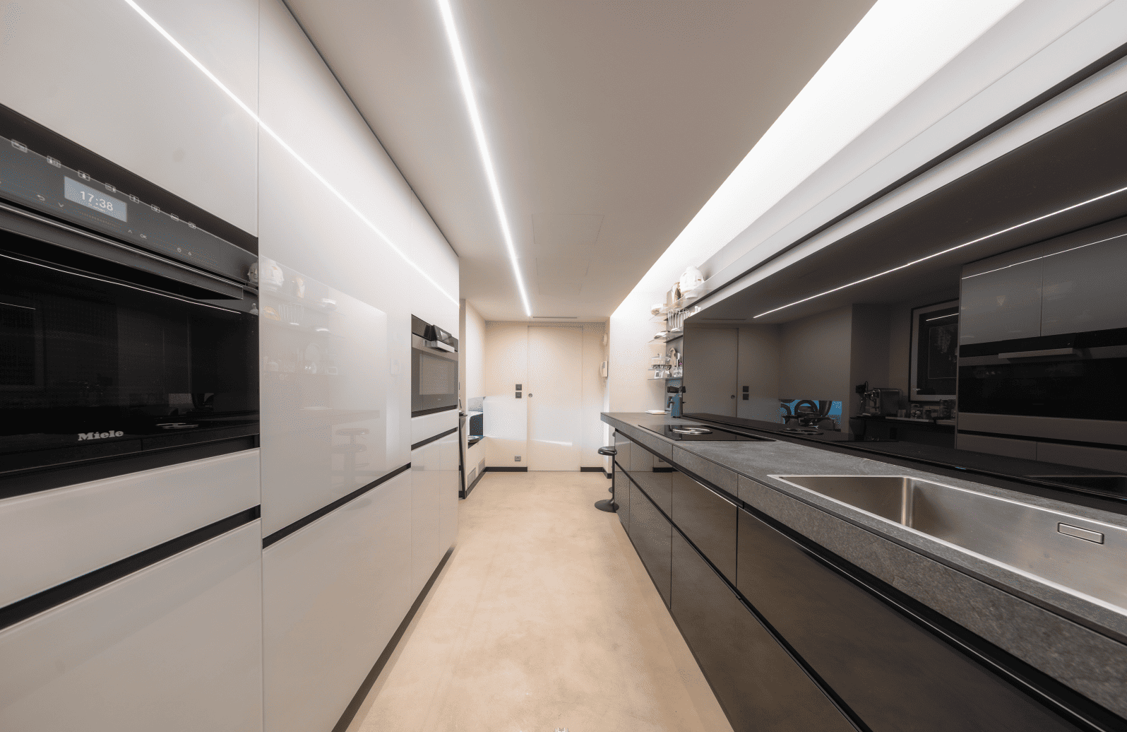 Modern kitchen with black and white appliances and design elements.