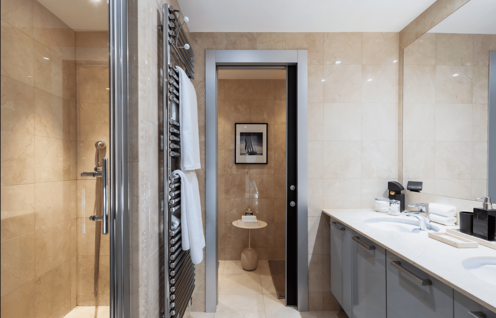 Bathroom interior with shower, towel rack, and sink area.