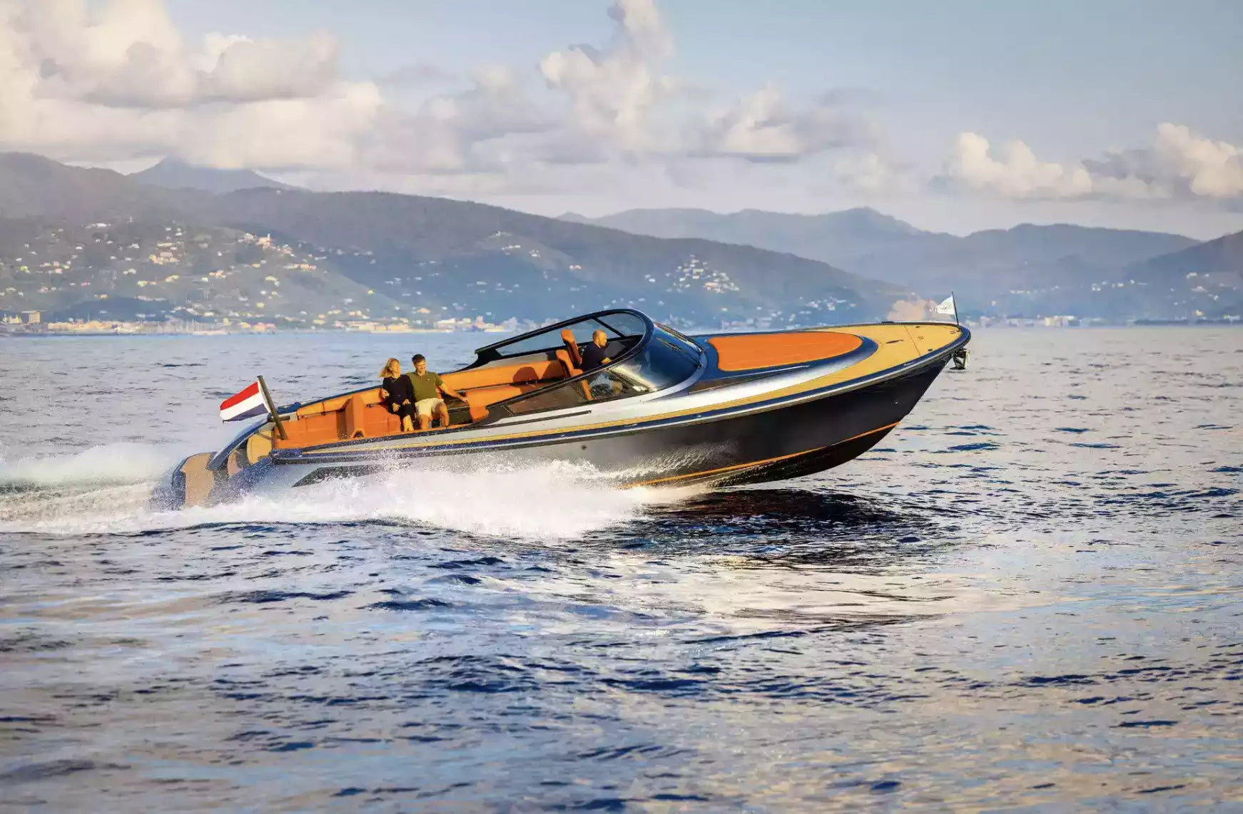 Speedboat on the water with mountains in the background