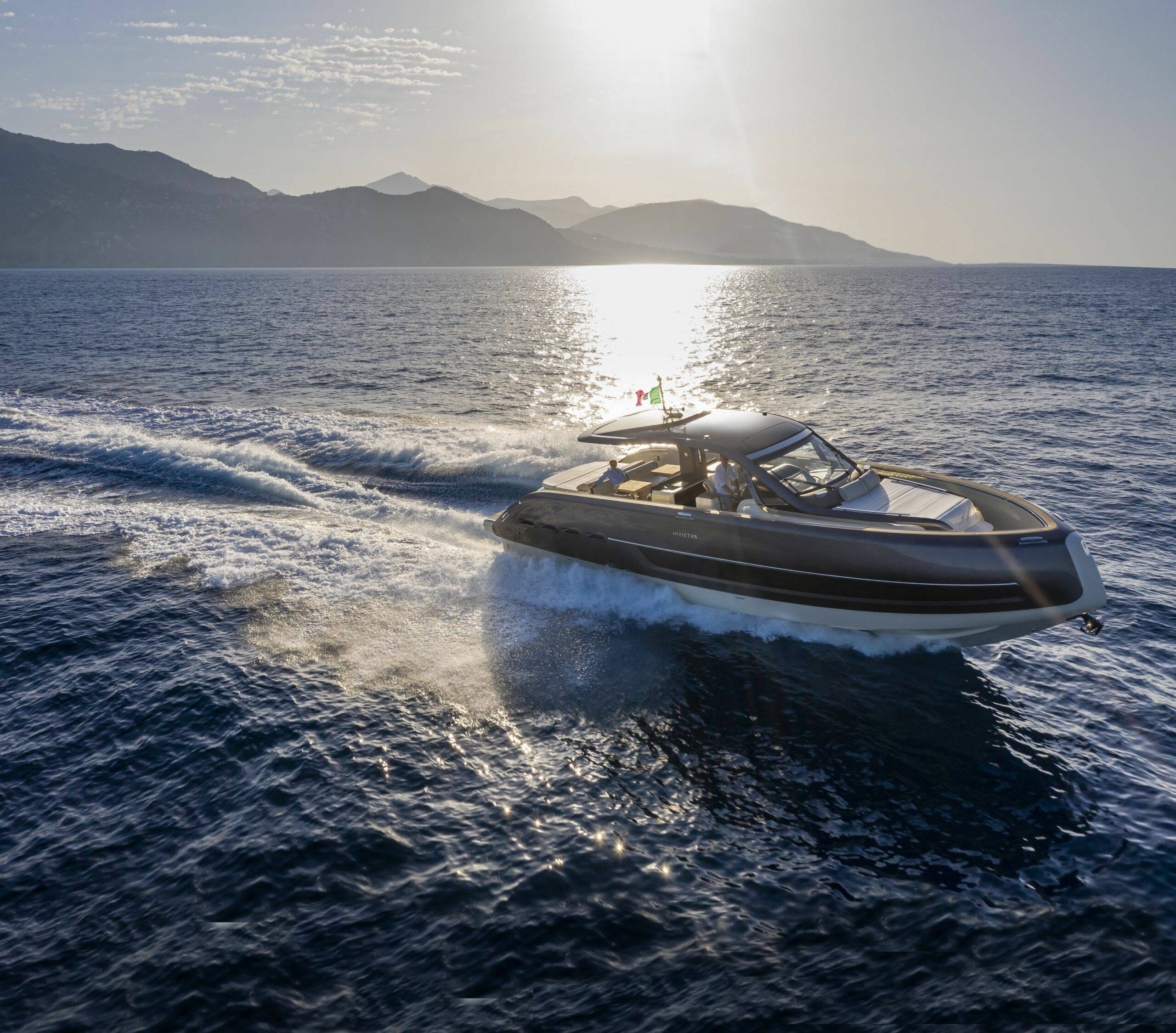 Speedboat on the open water with mountains in the background