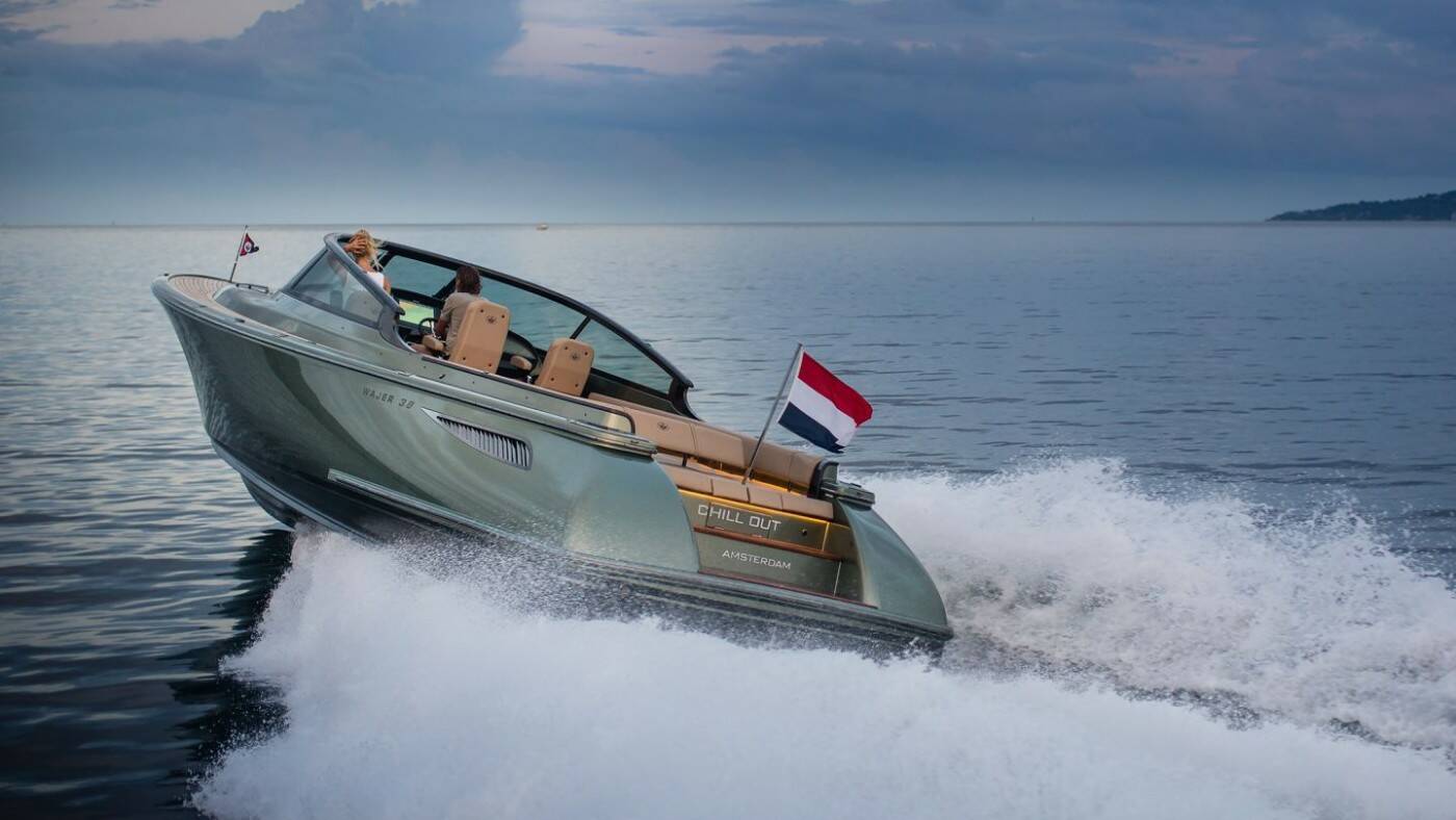Speedboat on a body of water with a clear sky