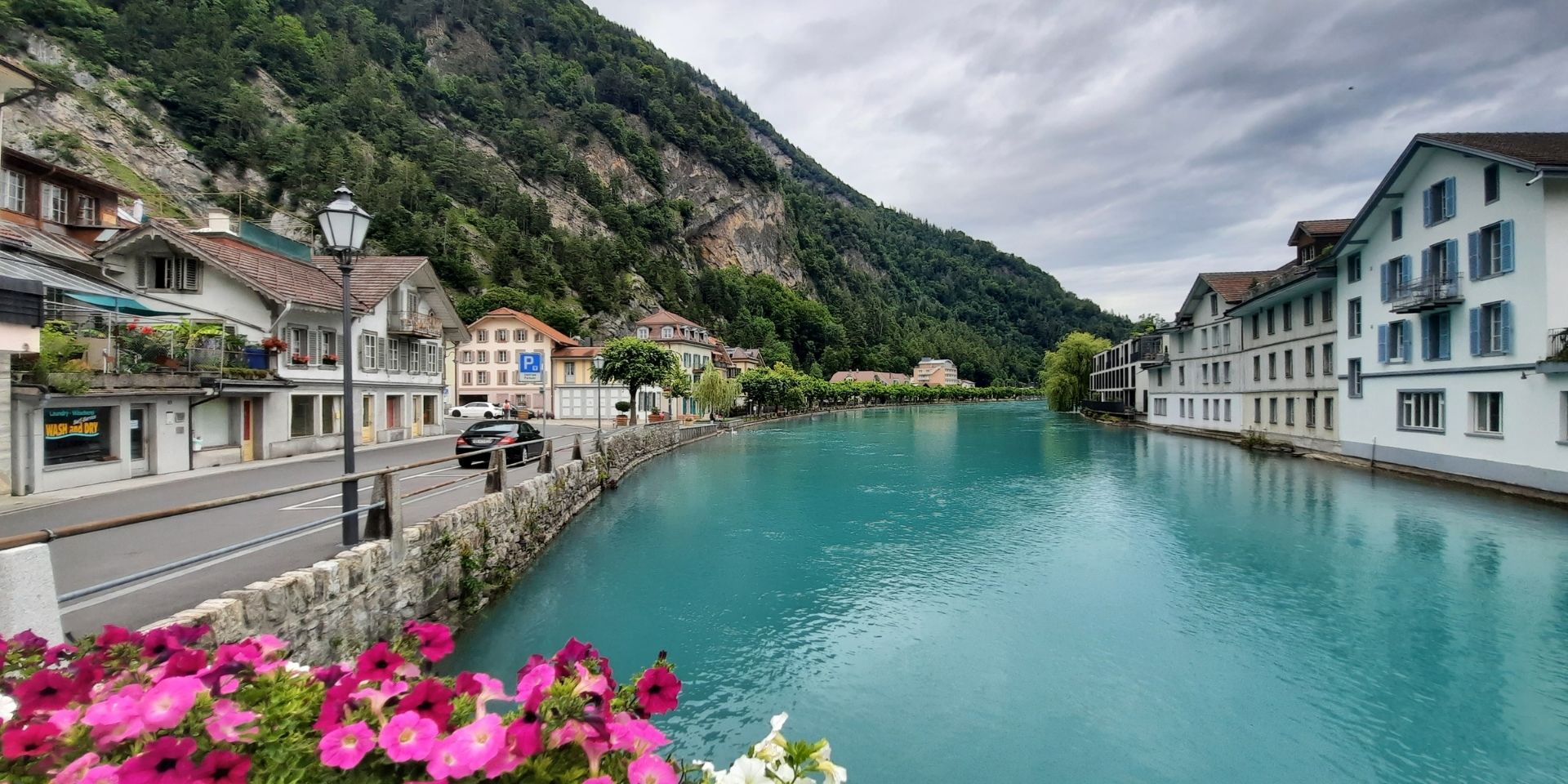 Town by a river with mountains in the background